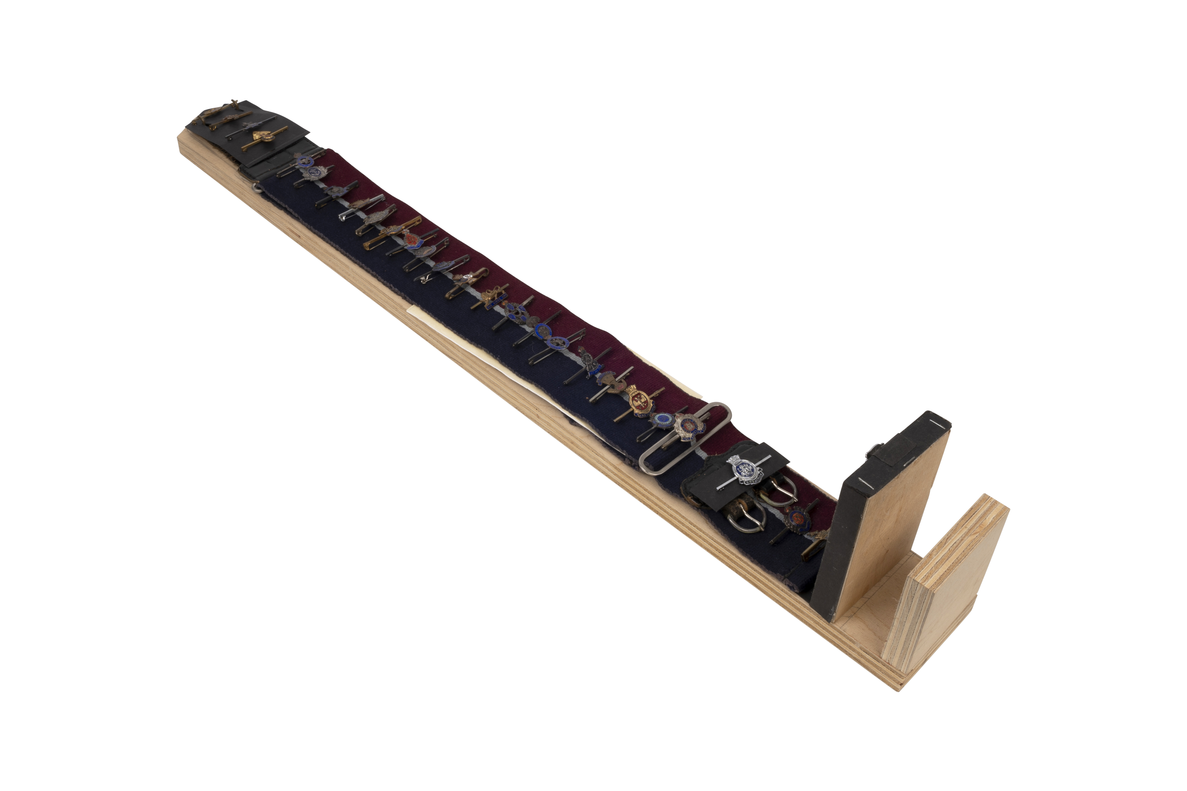 Display of British Military Tie-Pins on a R.A.F. stable belt (29 items)