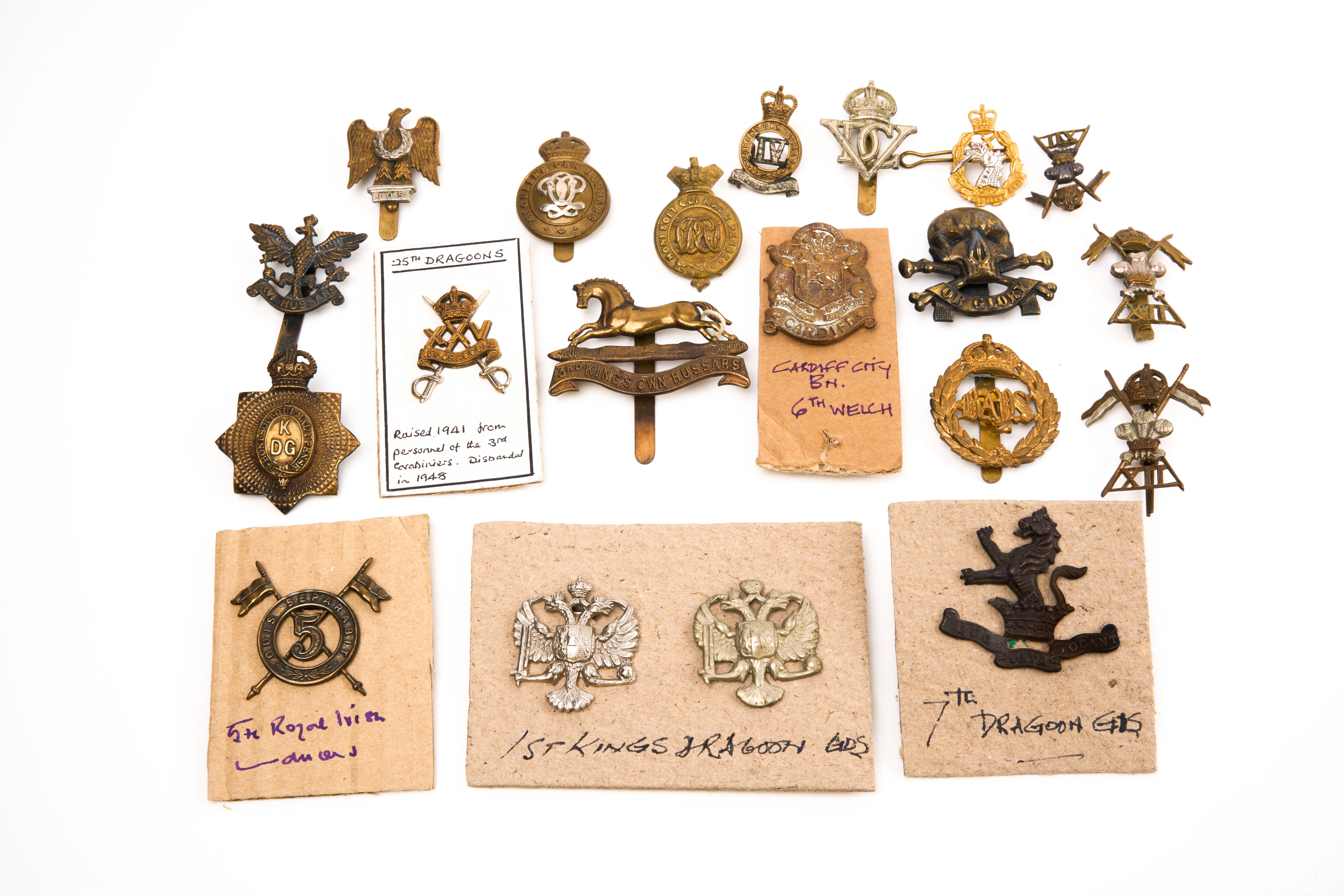 20 British cap badges, loose in envelope.