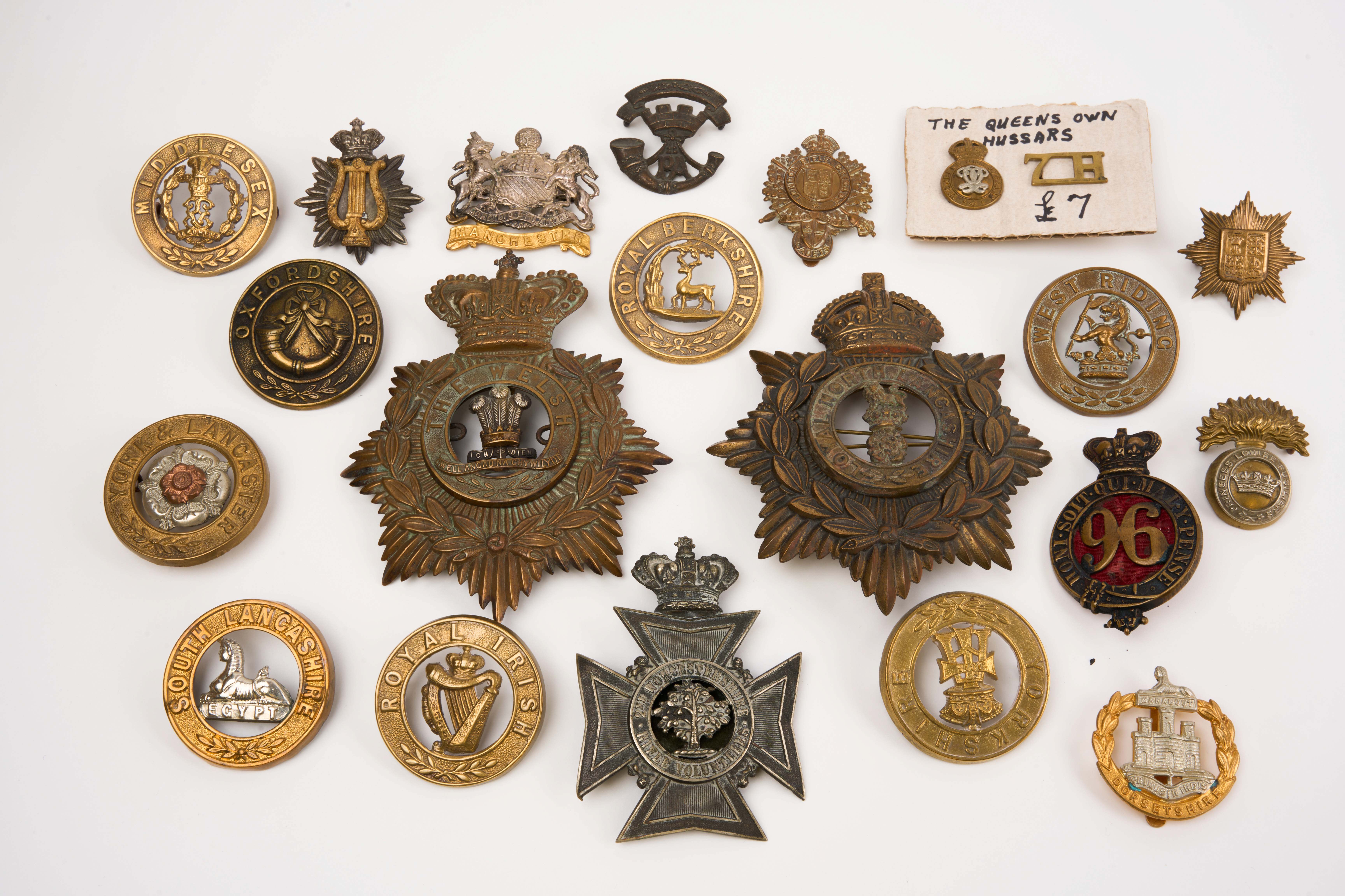 21 British and Commonwealth cap badges and helmet plates, loose in envelope