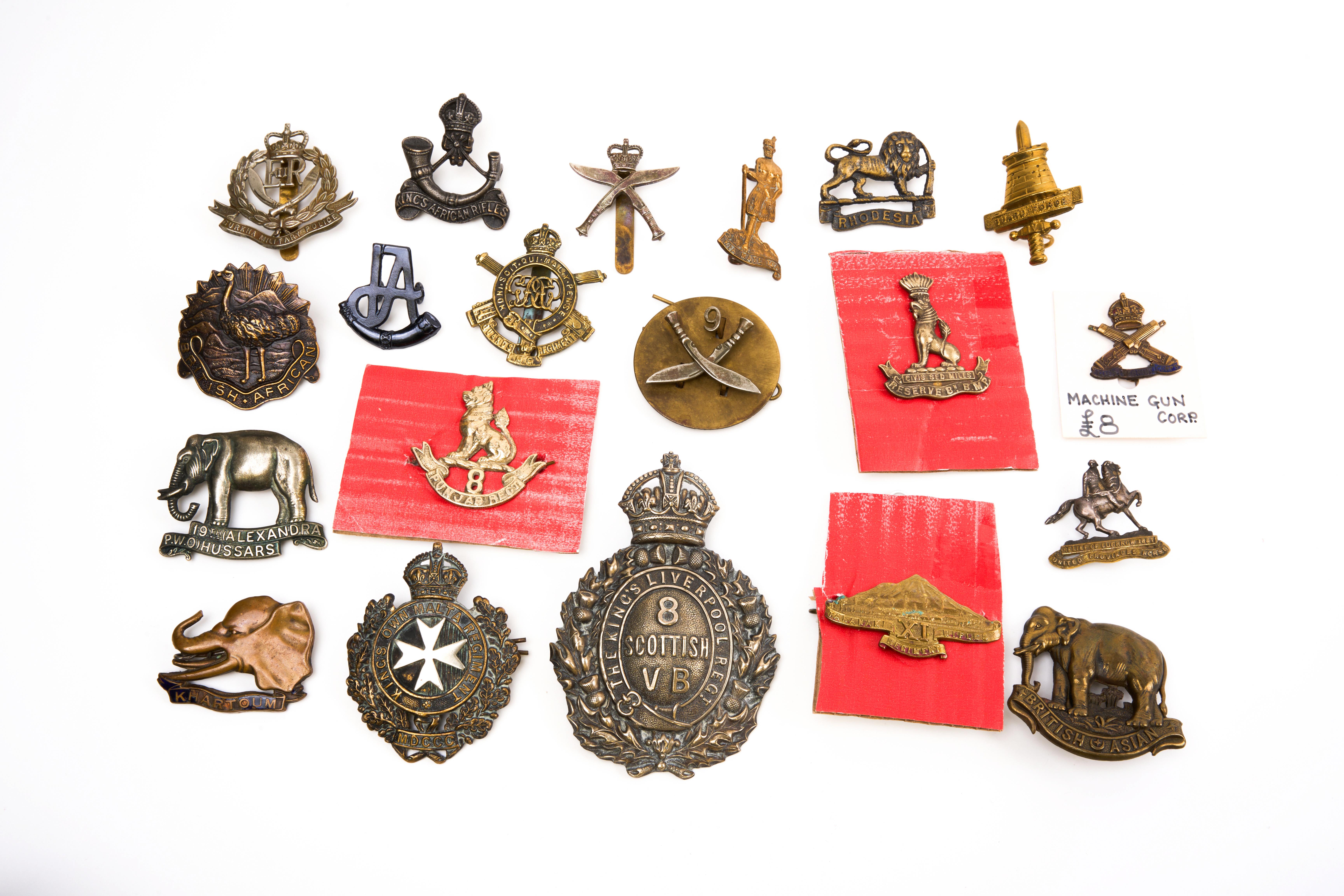 20 British and Commonwealth cap badges and helmet plate, loose in envelope