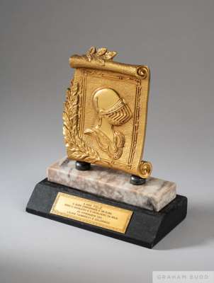 A gold tone trophy depicting a knight on two tiers of marble presented to Pelé 
 by Tamakavy and Colorado during the Knight and Gentlemen's Ball. The 