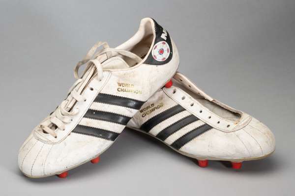 A pair of Washington Diplomat's Bobby Stokes white Adidas World Champion NASL football boots, 
 white leather boots with Adidas navy three side stripe
