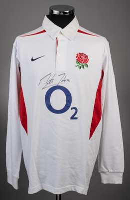 A white England rugby jersey signed by Martin Johnson, 
 Nike, L, with button-up collar and embroidered badge, unnumbered