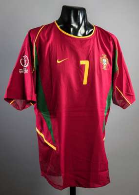 Luis Figo red Portugal No.7 jersey from the 2002 World Cup, short-sleeved, FIFA tournament logo to right sleeve  It is not known which particular matc