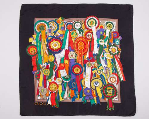 A Gucci silk scarf featuring a colourful design of international horse show winners' rosettes