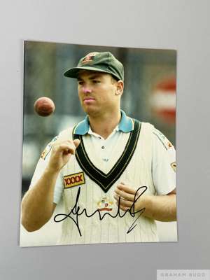 Excellent cricket coloured signed photograph of Shane Warne, 
 10 x 8in., shows close up of Warne in Australian sweater and cap, sponsored by Castlema