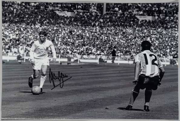 Alan Ball signed b&w photograph of Ball in action for England v Argentina during the 1966 World World Cup match, 
 12 by 8in., signed in black marker 