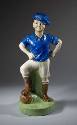 A Britannia Pottery 'Wee MacGregor' football figure decorated in the colours of Glasgow Rangers circa 1900,
 Rd. Patt. 366136, height 37cm., good cond