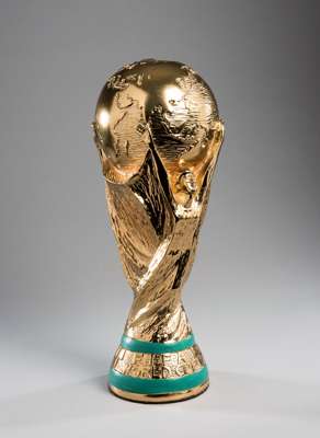 A full-size replica of the FIFA World Cup trophy, height 35cm., extremely heavy weighing some 4kg., gilt finish, green painted 'malachite' bands 