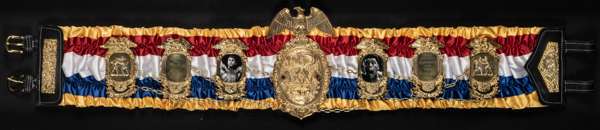 A unique replica of Muhammad Ali's first championship boxing belt for the defeat of Sonny Liston 25 February 1964, 
 with inscription and photographic