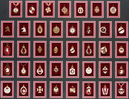 A complete set of Ranelagh Polo Club member's badges 1899 to 1938, 39 gilt-metal & enamel badges individually mounted in chronological order, framed &