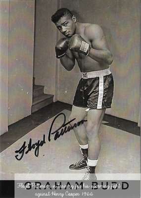 Boxing: Floyd Patterson signed 6 x 4in. b/w postcard photograph showing Floyd in pose during training for his upcoming fight with Henry Cooper back in