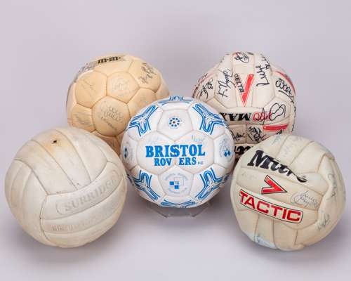 Five various autographed footballs