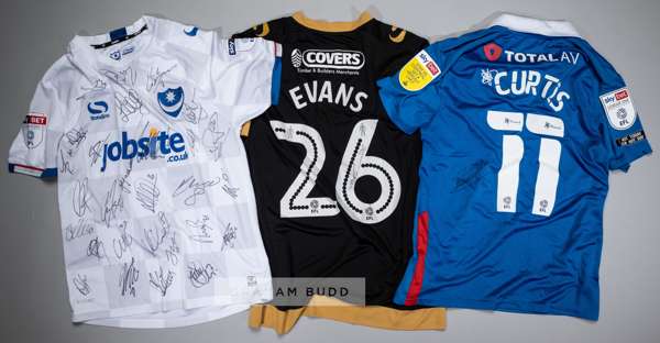 Three signed Portsmouth FC jersey's,
 comprising: a Curtis Main squad signed white no.14 away jersey, season 2017-18, short-sleeved with SKYBET LEAGUE