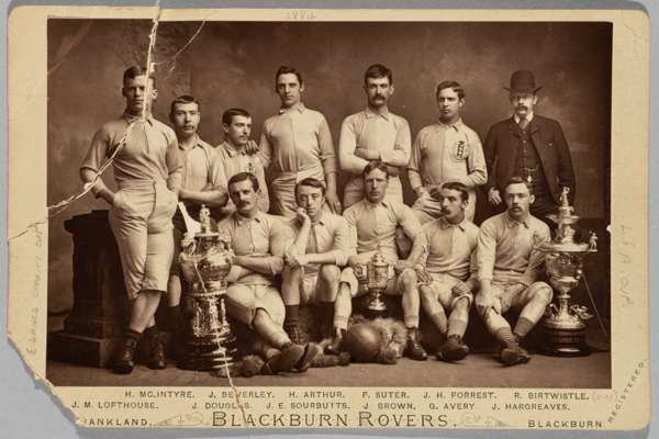 Rare cabinet card photograph of the Blackburn Rovers team in 1884 posing with the three trophies the club won in that year - the F.A. Cup, The Lancash