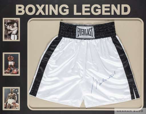 Pair of autographed Muhammad Ali autographed Everlast boxing trunks
 authenticated by OnlineAuthentics.com, OA-8268748, in common-mount, framed and gl
