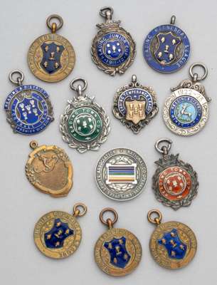 A group of medals relating to football in Reading,
 mostly in silver and enamel, others in bronze and gilt, competitions including Reading & District 