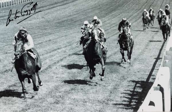 Lester Piggott signed b&w photograph,
 depicting the legendary jockey passing the winning post aboard Nijinsky in the 1970 Epsom Derby, signed in blac