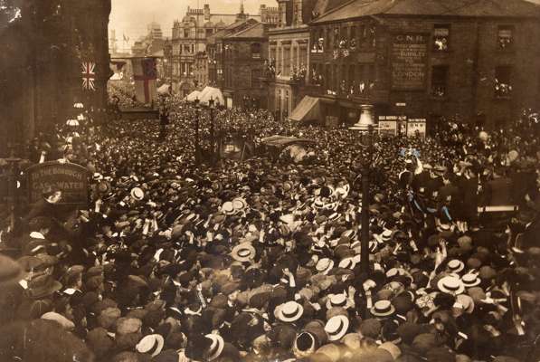 A superb black & white photograph titled Arrival of the Cup in Burnley 1914, the large 21 by 30in. photograph showing the excited crowd scenes as the 