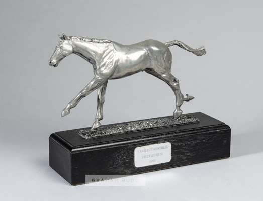 The winning trainer's trophy for the Hamilton Memorial Steeplechase at Kelso on 23rd February 1990,
 pewter modelled as a racehorse, raised upon a woo