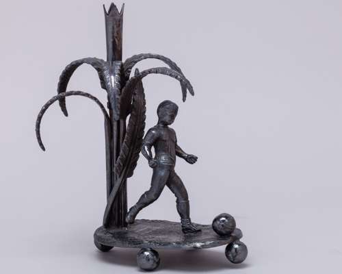 A Victorian white-metal glass posy holder modelled as a footballer