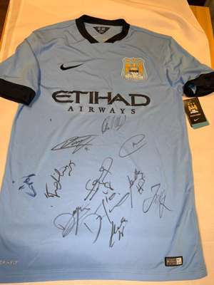 Team-signed blue Manchester City replica jersey 2014-15,
 Nike, short-sleeved with club crest and sponsor logo, signed on front in marker pen, with re