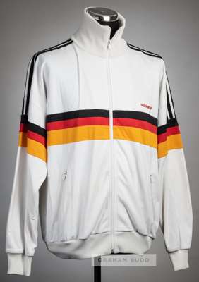 White West Germany tracksuit jacket, circa 1980s,
 Adidas, long-sleeved zip-up jacket with typical black, red and orange colours, reverse lettered BUN