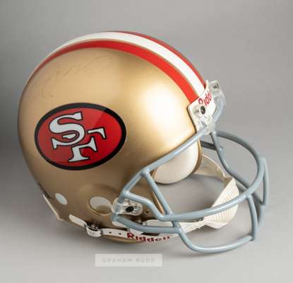 San Francisco 49ers official replica helmet signed by legendary quarterback Joe Montana,
 the Riddell gilt helmet with red and white stripes, bearing 