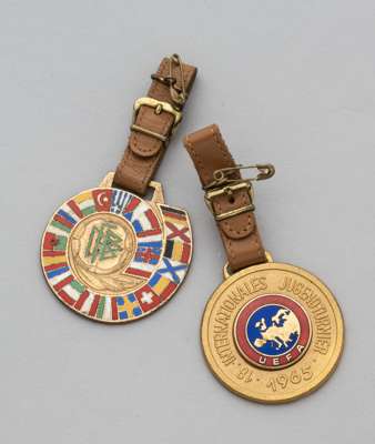 Two gilt-metal and enamel youth medallions, 
 the obverse of one inscribed Wir Grussen Die Jugend Europas, the reverse inscribed 18 Internationales Ju