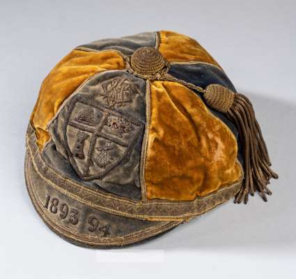 Westmorland County representative cap, 1893-94,
 gold and navy velvet cap with gilt tassel and braiding, embroidered with entwined letters CFA above a