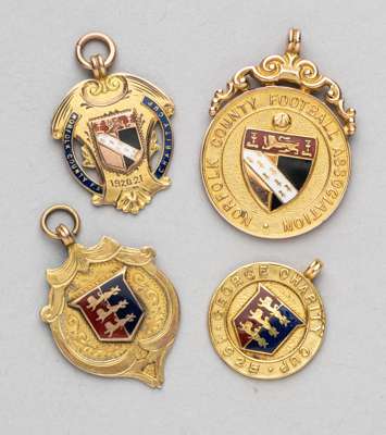 A group of four gold and enamel medals relating to Norfolk football,
 comprising Norfolk County FA Charity Cup 1920-21, Great Yarmouth Charity Cup 192