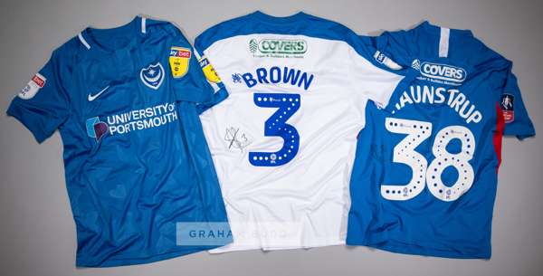 Three signed Portsmouth FC jersey's,
 comprising Gareth Evans blue and white no.26 home jersey, season 2018-19, short-sleeved with SKYBET WHEN THE FUN