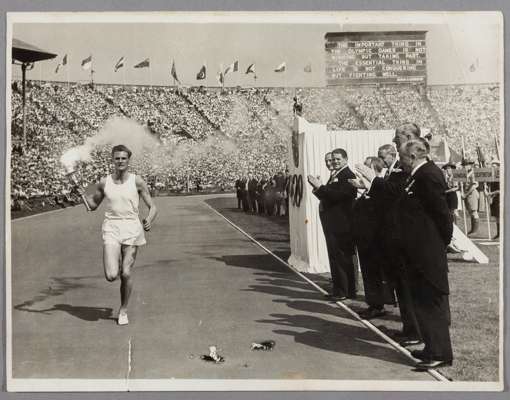 OLYMPIC GAMES TORCH 29th JULY 1948 – ORIGINAL PHOTOGRAPH OF MARK JOHN DELIVERING THE TORCH TO WEMBLEY STADIUM. 

The 1948 Summer Olympics torch relay 