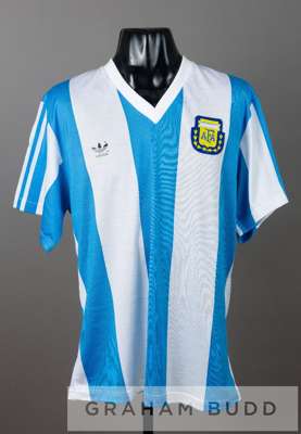 Blue and white striped Argentina No.23 home jersey, circa 1990,
 short-sleeved with country crest and sponsor logo, reverse numbered 23

 This design 