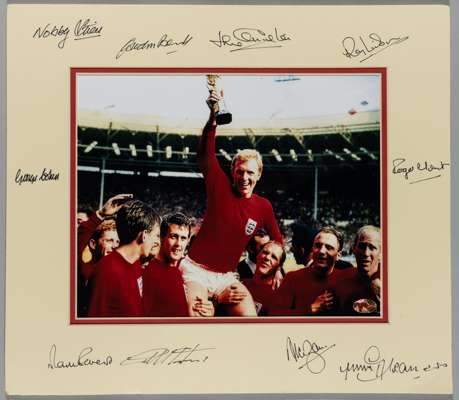 England World Cup-Winners colour photograph of the England 1966 World Cup-winning side holding captain Booby Moore aloft with the Jules Rimet trophy, 
