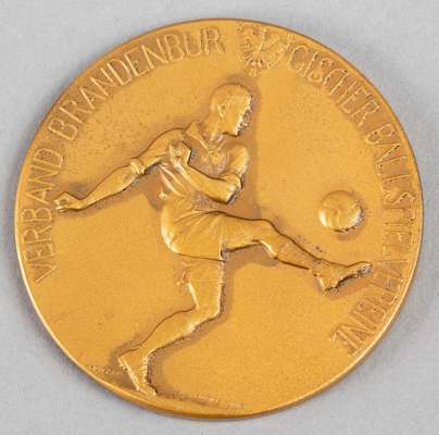 Five football medals and one football badge,
  comprising: i) a German football medal dated 13th May 1928, bronze, obverse with a footballer kicking a