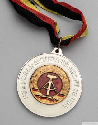 1985 white-metal and enamel German Football Championship medal 
 the obverse inscribed DEUTSCHER FUSSBALLVERBAND DER DDR, 1984-85, the reverse inscrib