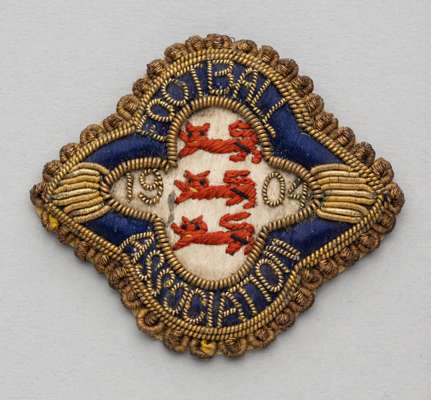 Football Association badge 1904,
 silk and wirework badge with FOOTBALL ASSOCIATION 1904 and three lion emblem, reverse with lapel pin clasp, and make