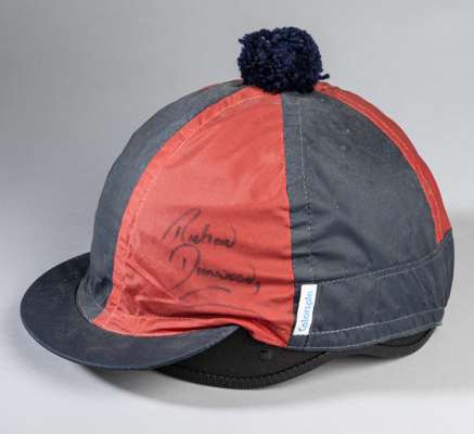 Richard Dunwoody signed racehorse work riding helmet and cover,
 the COMPETITOR riding helmet with red and navy cover with navy wool pommel, signed in