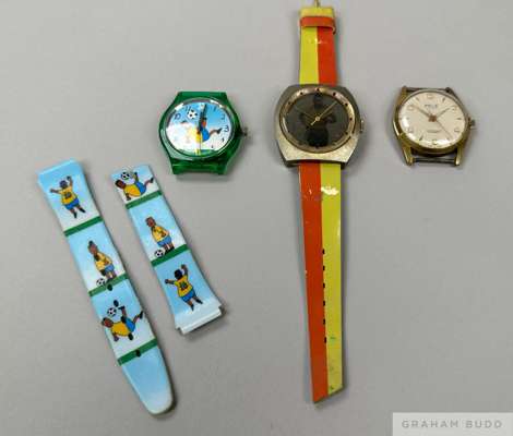 A group of three watches commemorating Pelé. 
 The first is a watch with a round dial marked "Pelé 17 Jewels," no strap. The second is an unmarked wat