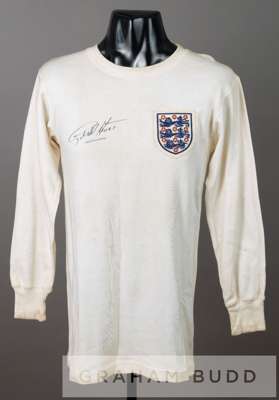A white England No.9 jersey circa 1964 signed by Geoff Hurst,
 by Bukta, long-sleeved embroidered with the England three lion badge, reverse numbered 