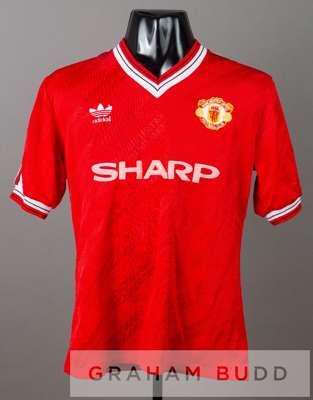 Steve Bruce signed red Manchester United no.4 home jersey, season 1987-88,
 by Adidas, short-sleeved with club crest and sponsor logo, reverse numbere