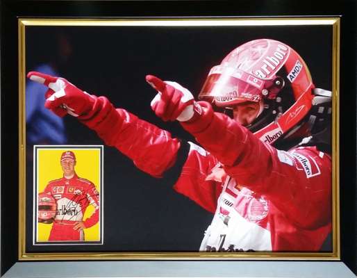 Michael Schumacher seven times F1 World Champion signed and framed display, 
 measuring 69 by 55cm., features an official Ferrari sponsors postcard au