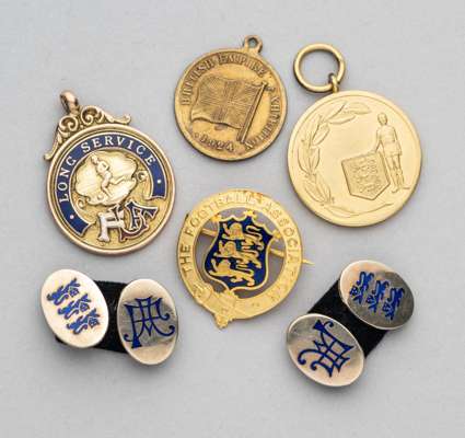 Football Association long service medal awarded to K.V. Ducker in 1931,
 9ct gold and enamel, inscribed obverse and reverse, weight 14gms., diameter 2