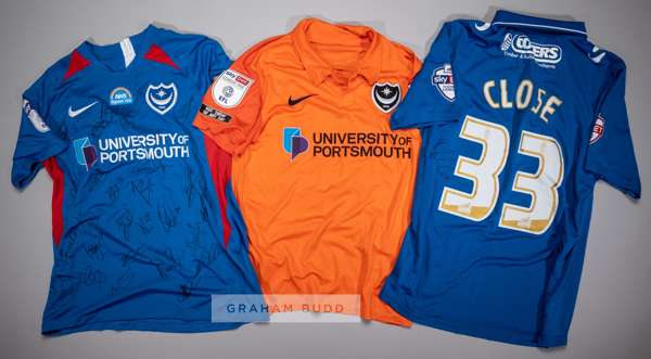 Three signed Portsmouth FC jersey's,
 comprising Callum Johnson orange no.2 third choice jersey, season 2020-21, short-sleeved with SKYBET LEAGUE ONE 