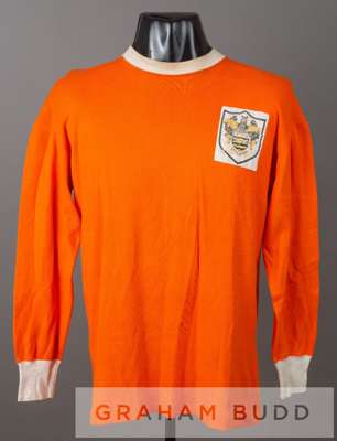 Tangerine Blackpool No.2 home jersey, circa 1966,
 by Umbro, long-sleeved, white collar and cuffs, embroidered cloth club badge, reverse number in whi