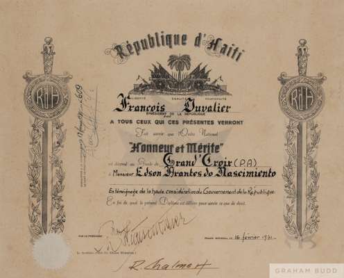 A framed, grand cross national honour of merit certificate presented to Pelé by the Republic of Haiti. 
 Appears to be hand signed by Haitian Presiden