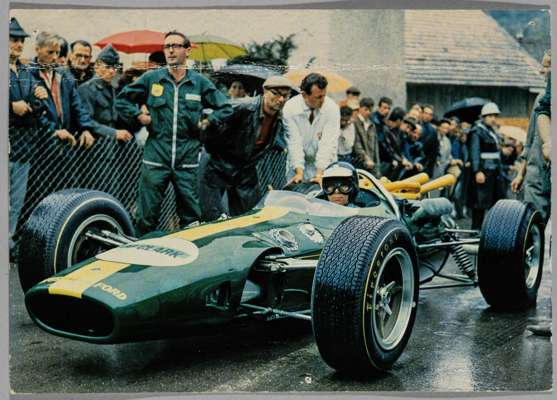 Very rare and sort after autograph of British race car driver Jim Clark,
 signed in ink on back of postcard which shows Jim Clark with mechanics at st