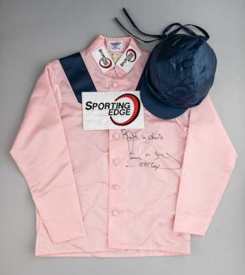 Tony McCoy signed racing silks,
 the colours of Corbett Stud, pink jacket with dark blue epaulets and cap, signed in black marker by the record breaki