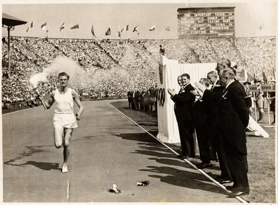 OLYMPIC GAMES TORCH LONDON 29th JULY 1948, ORIGINAL PHOTOGRAPH OF MARK JOHN DELIVERING THE TORCH TO WEMBLEY STADIUM, 

The 1948 Summer Olympics torch 